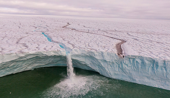 Waterfall off the Brasvelbreen glacier ice sheet